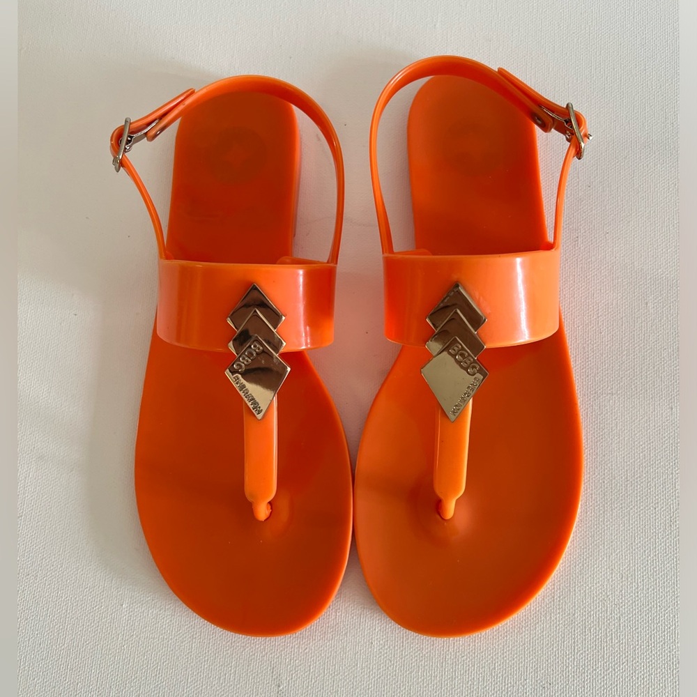 BCBGeneration Orange Jelly Sandals Womens Sz 7 Flat Thong Gold Logo Accents Slim